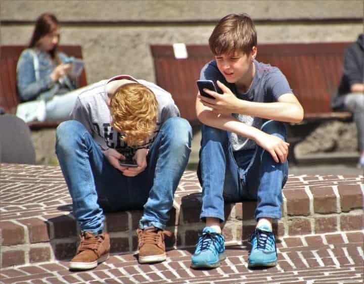 Two boys on cell phones